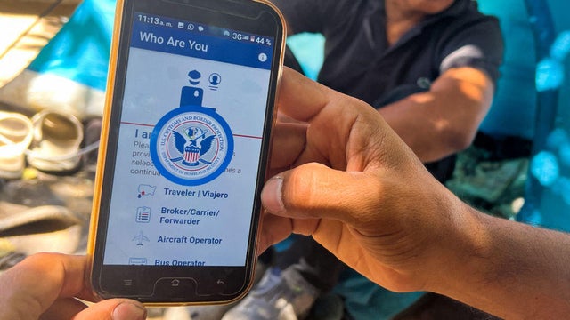 A migrant shows the CBP One app from Customs and Border Protection, which is used to apply for an appointment to claim asylum, in Ciudad Juárez, Mexico, on May 10, 2023. 