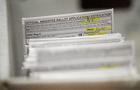 Absentee ballots are seen during a count in Milwaukee on Tuesday, Nov. 8, 2022. 
