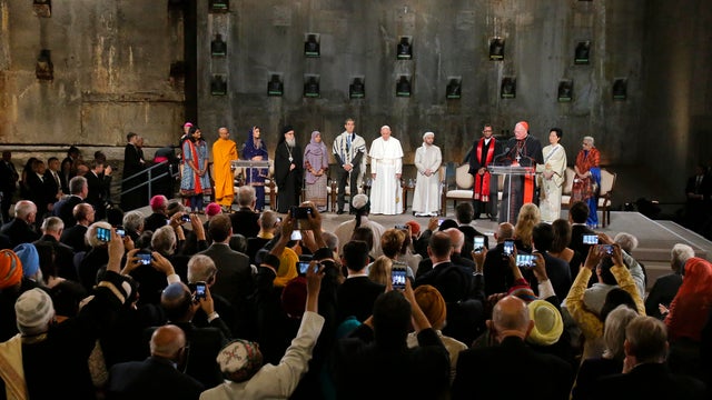 People take photos of Pope Francis during a multi-religious ceremony at the 9/11 Memorial and Museum on on September 25, 2015 in New York City. 