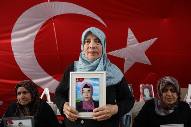 Hatice Levent holds a picture of her daughter Fadime who is believed to have joined the outlawed PKK, during a gathering in Diyarbakir 