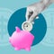 Time to earn. Time is money. Time Management. The hand is putting the clock as coin to piggy bank 