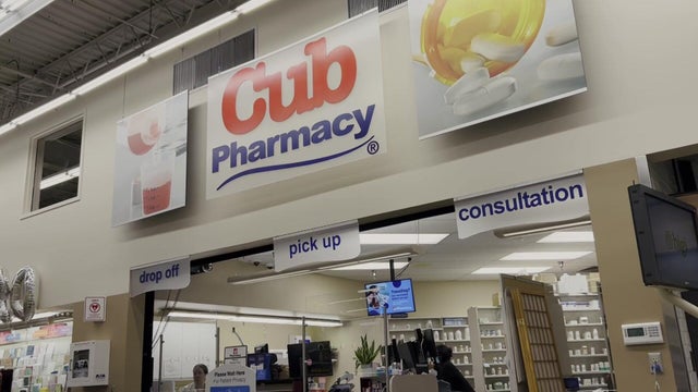A Pharmacy Counter With Medicine On Display 